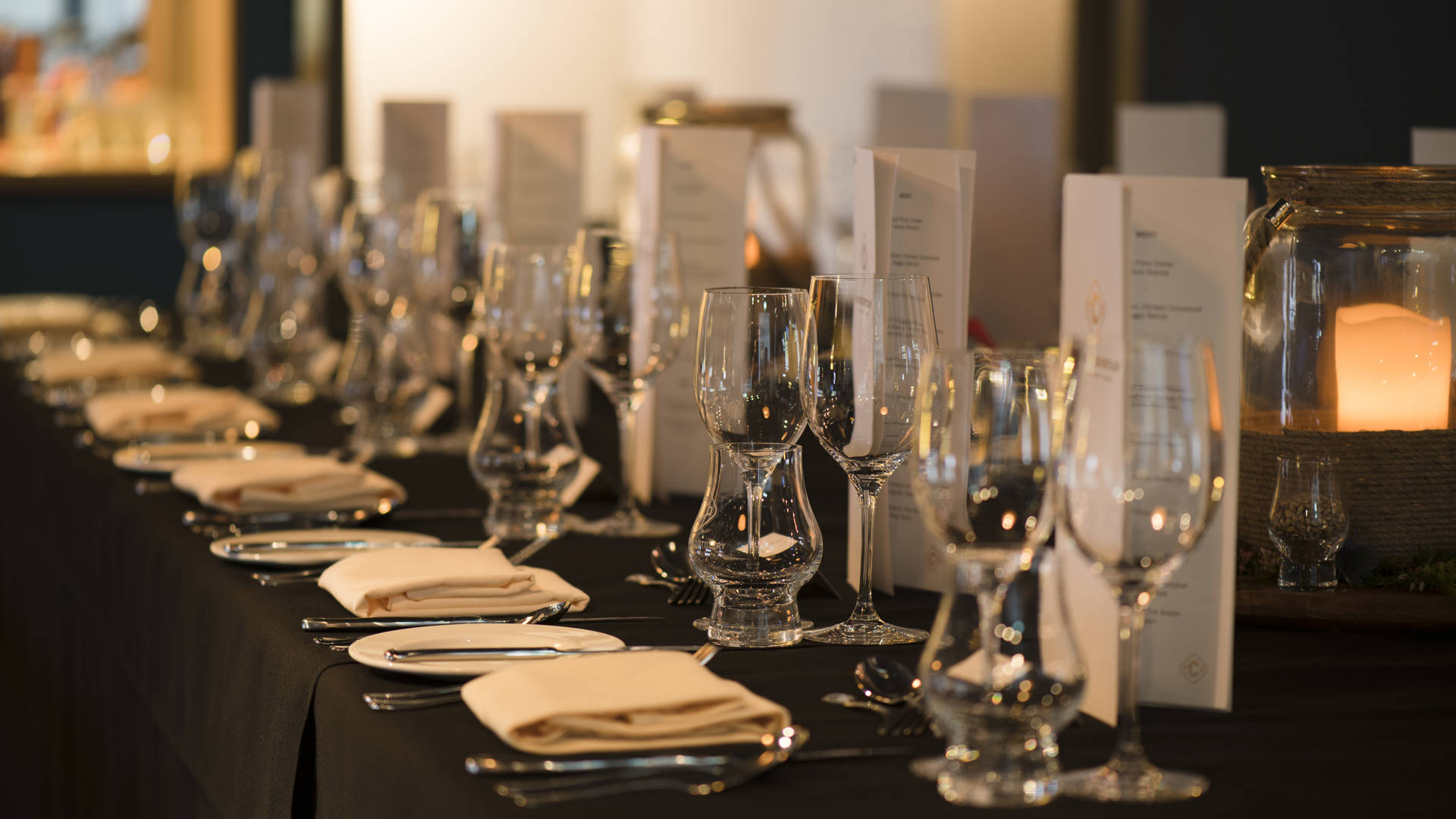 Table set up with cutlery, linen, menus, glasses and table decoration