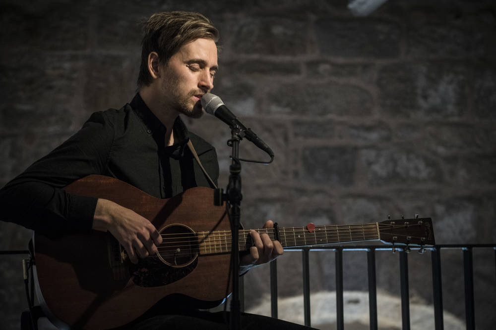 Acoustic singer with guitar playing at The Clydeside Distillery