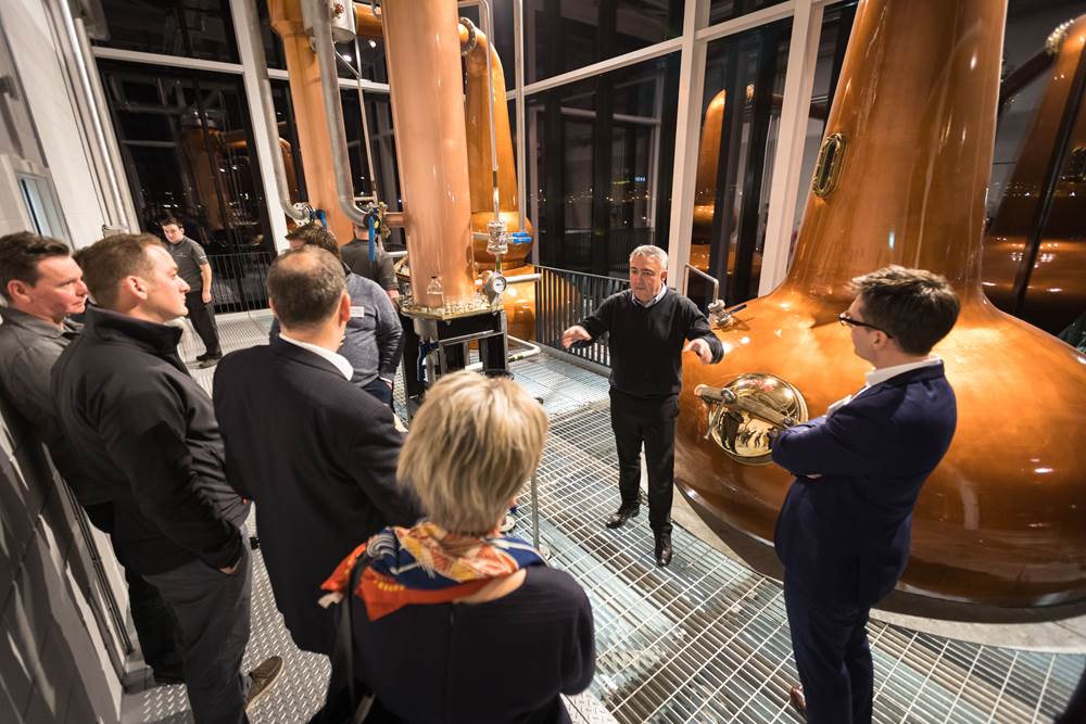 Alistair McDonald hosting group of guests during an evening tour at The Clydeside Distillery