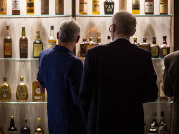 Group of guests enjoy the whisky collection at The Clydeside Distillery