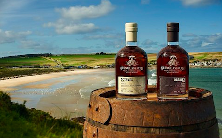 bottles of whisky in front of a landscape